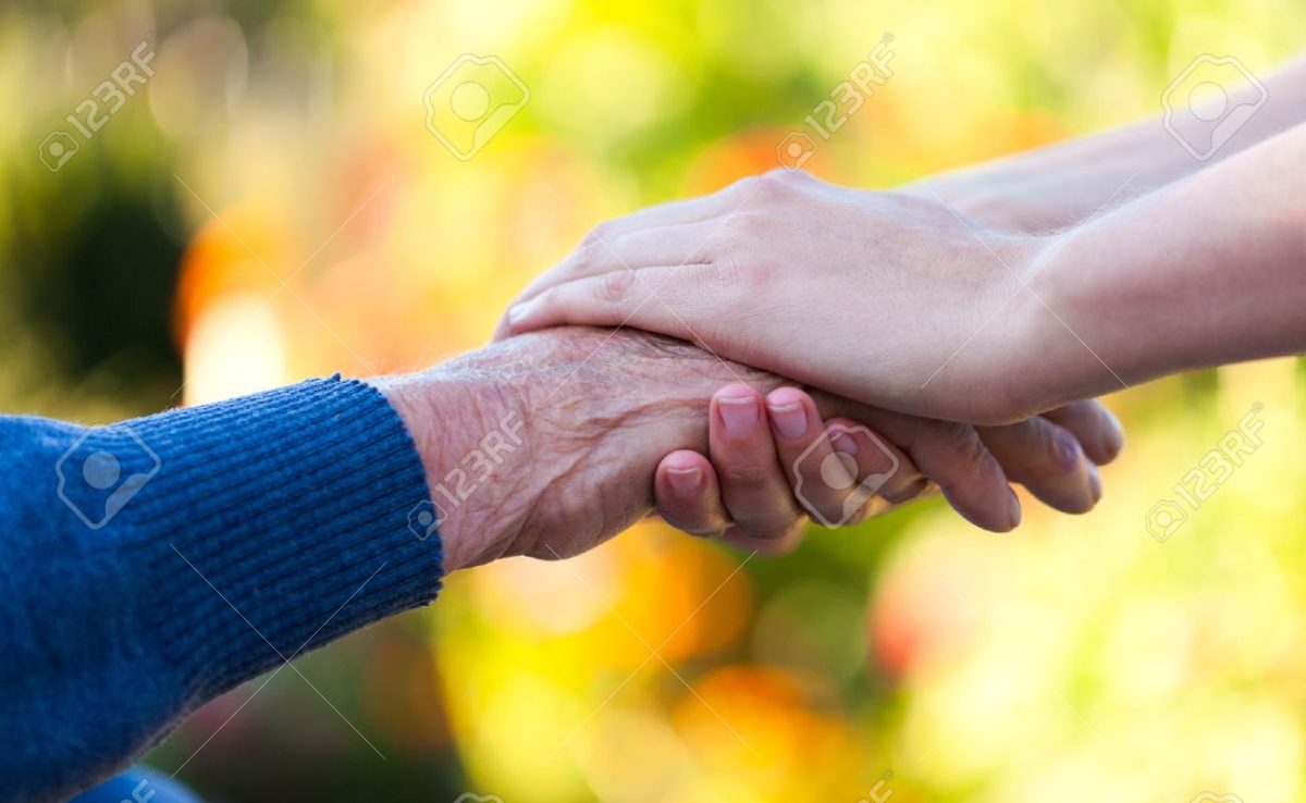 22401690-young-female-hand-holding-an-old-man